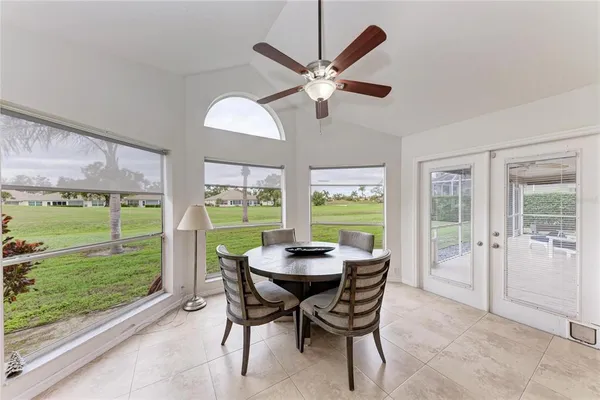 a spacious bedroom with a bed a chandelier and a window