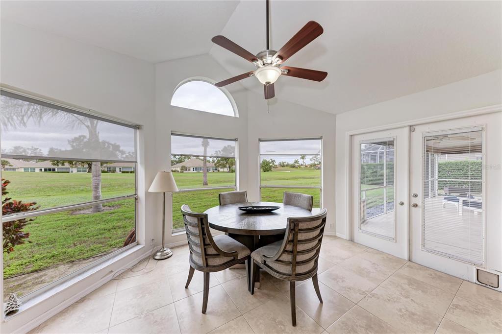 4906 Peridia Boulevard East Bradenton, FL 34203 - Photo 16 of 64 a dining room with furniture and a floor to ceiling window