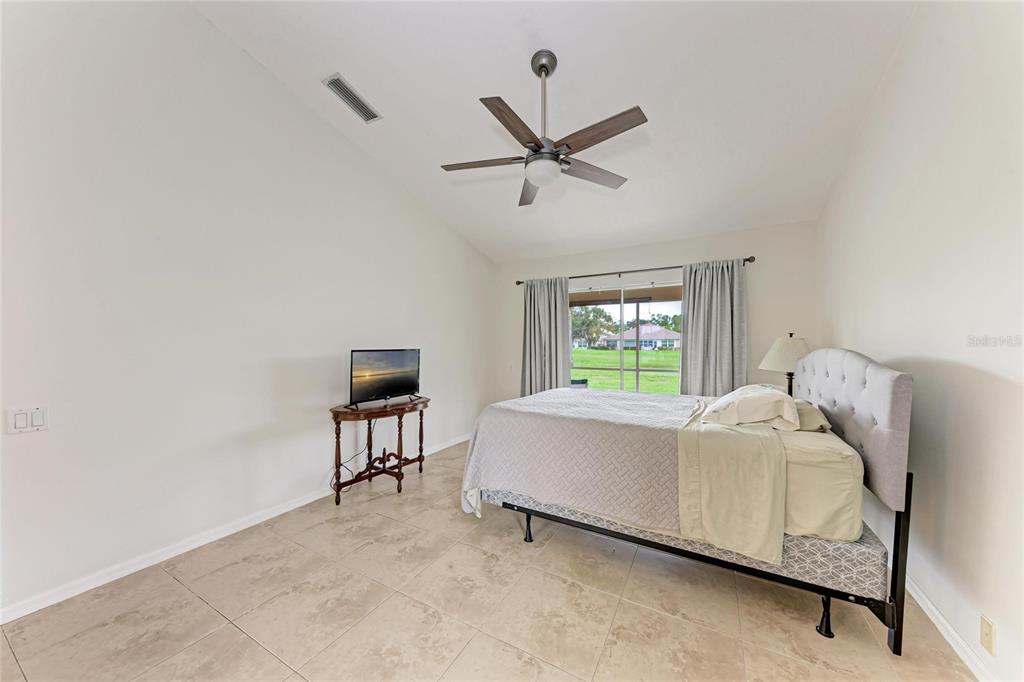 4906 Peridia Boulevard East Bradenton, FL 34203 - Photo 18 of 64 a bed room with a bed and a window