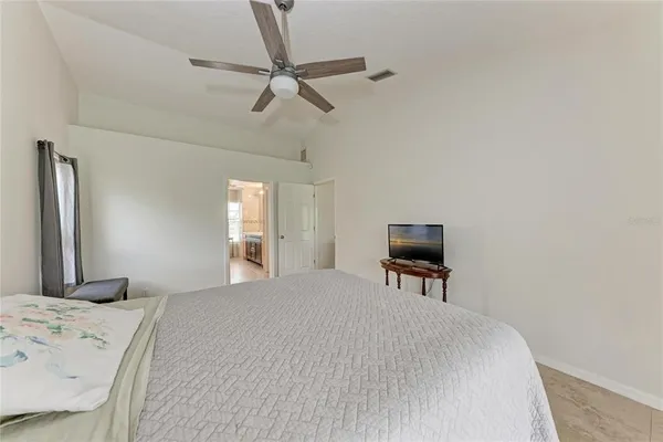 a spacious bathroom with a granite countertop sink a mirror and a shower
