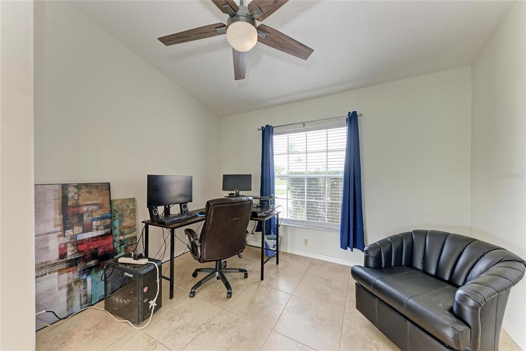 4906 Peridia Boulevard East Bradenton, FL 34203 - Photo 26 of 64 a view of a livingroom with workspace and a couch