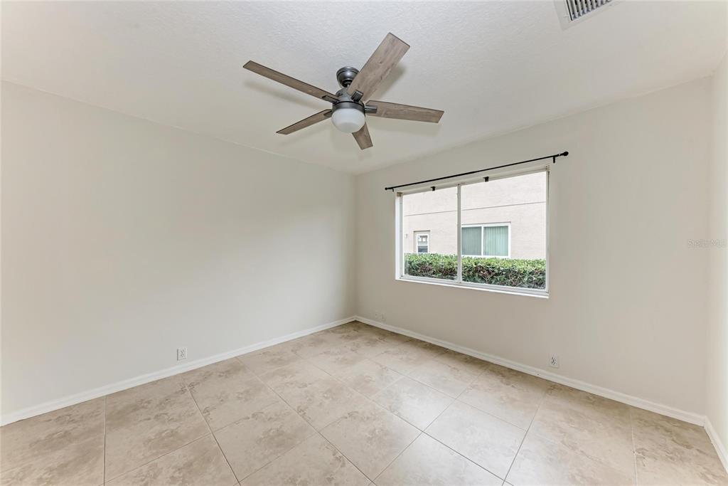 4906 Peridia Boulevard East Bradenton, FL 34203 - Photo 27 of 64 an empty room with a window and a fan