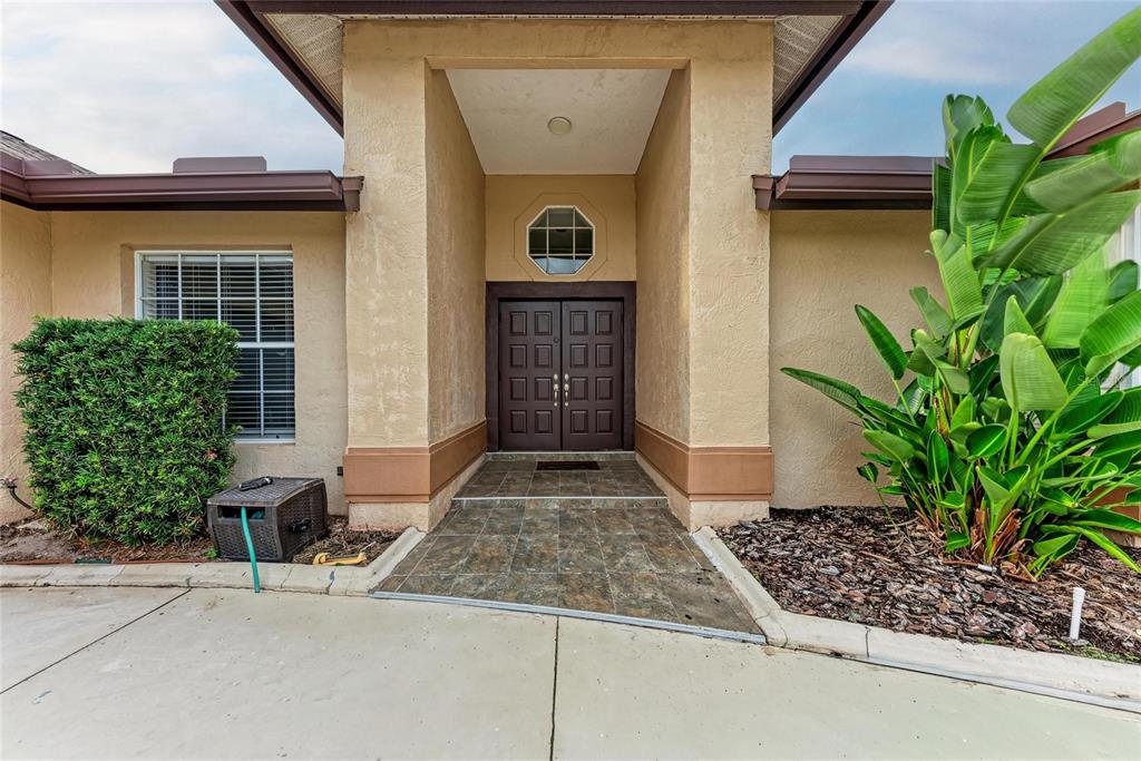 4906 Peridia Boulevard East Bradenton, FL 34203 - Photo 3 of 64 a front view of a house with garden
