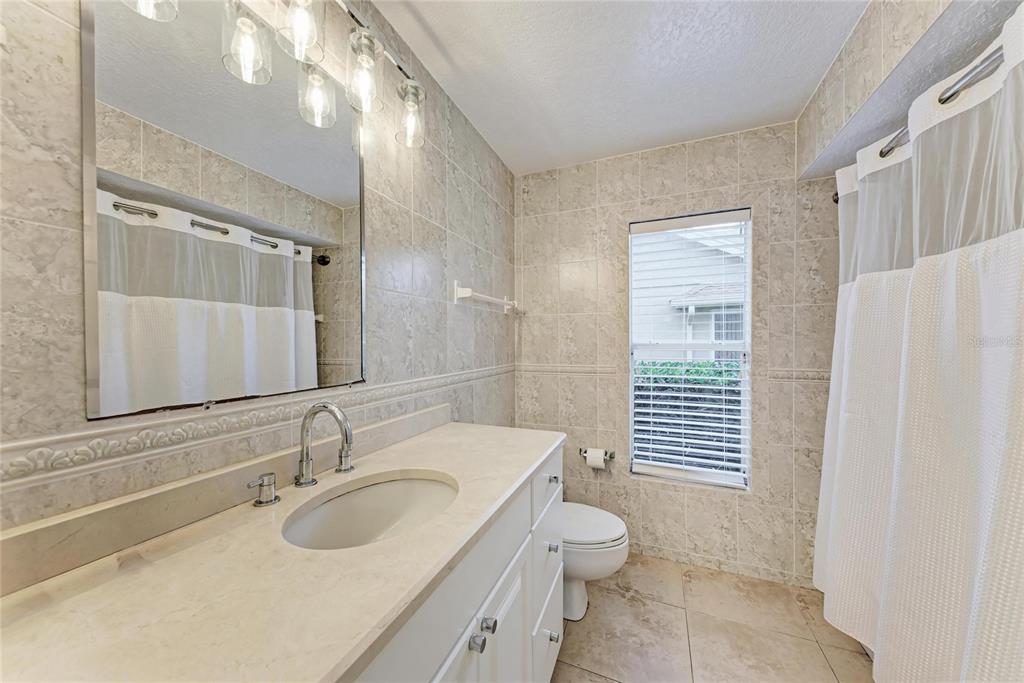 4906 Peridia Boulevard East Bradenton, FL 34203 - Photo 33 of 64 a bathroom with a sink toilet and shower
