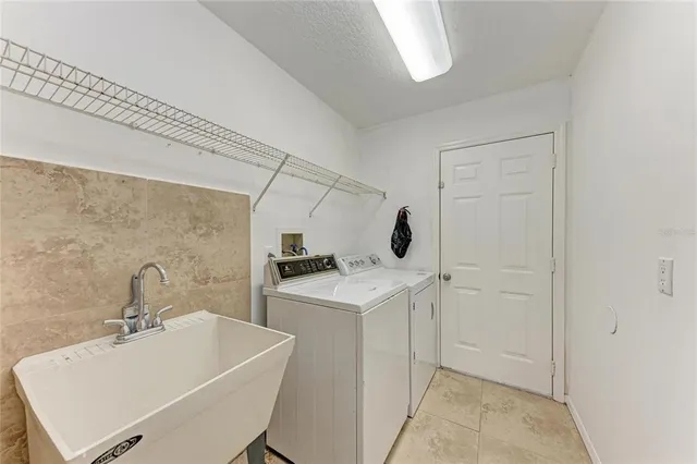 an aerial view of a city with lots of residential buildings ocean and mountain view in back