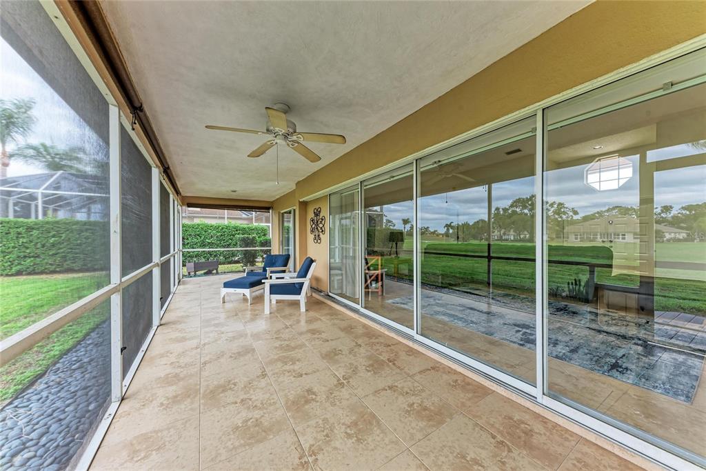 4906 Peridia Boulevard East Bradenton, FL 34203 - Photo 35 of 64 a view of a porch with chairs and backyard