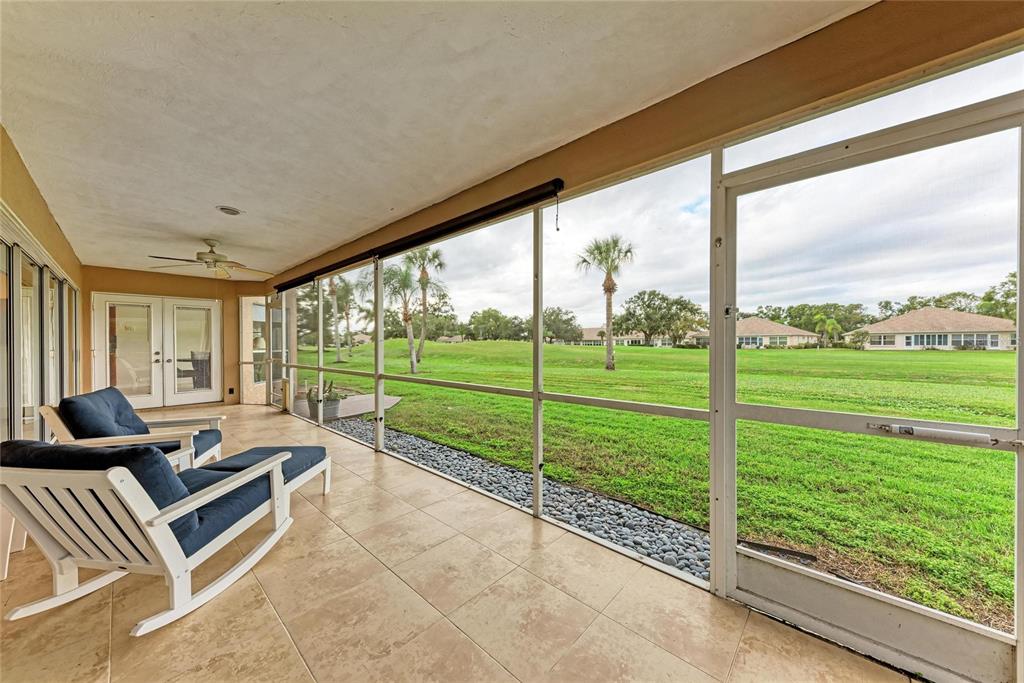 4906 Peridia Boulevard East Bradenton, FL 34203 - Photo 37 of 64 a living room with couch next to a yard