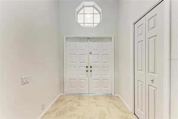 an empty room with wooden floor cabinet and window