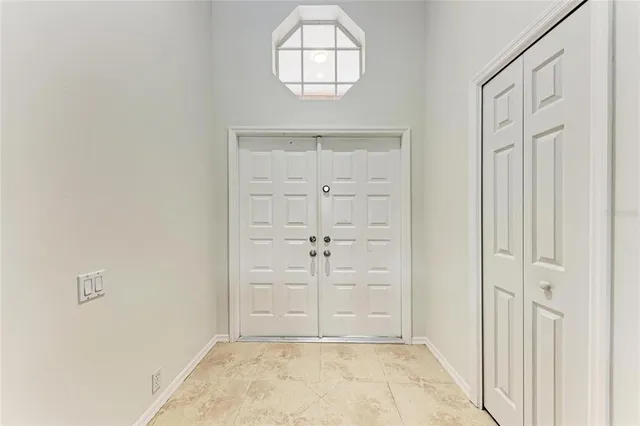 an empty room with wooden floor cabinet and window