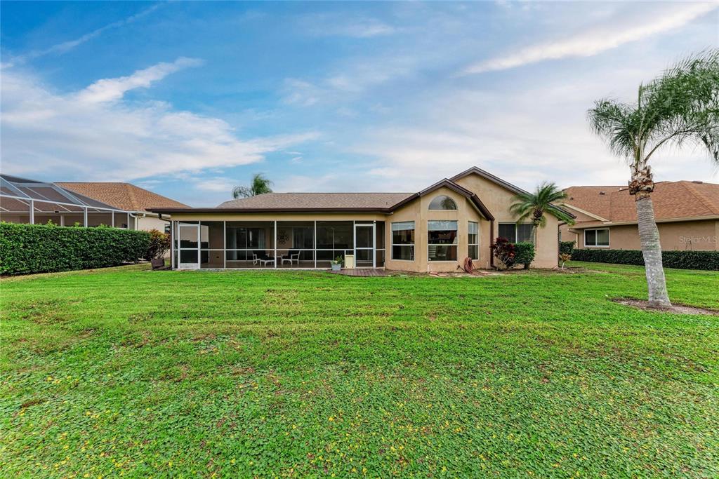 4906 Peridia Boulevard East Bradenton, FL 34203 - Photo 41 of 64 a front view of a house with a yard and potted plants