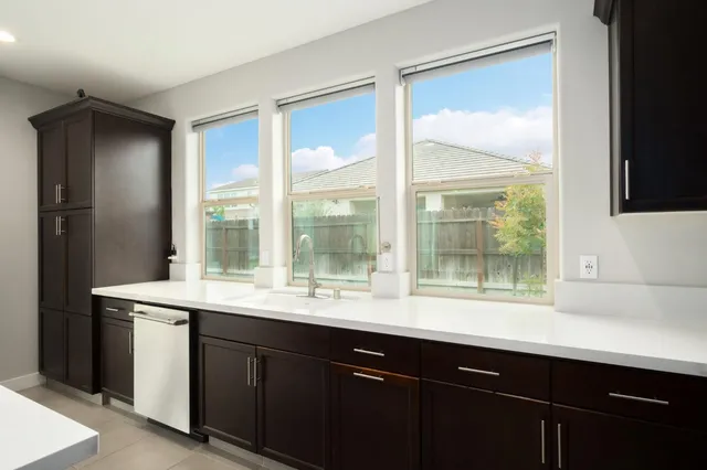 a large kitchen with a table and chairs