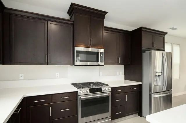 a kitchen with counter top and living room