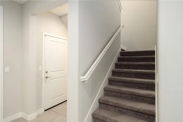 a spacious bedroom with a bed and a ceiling fan