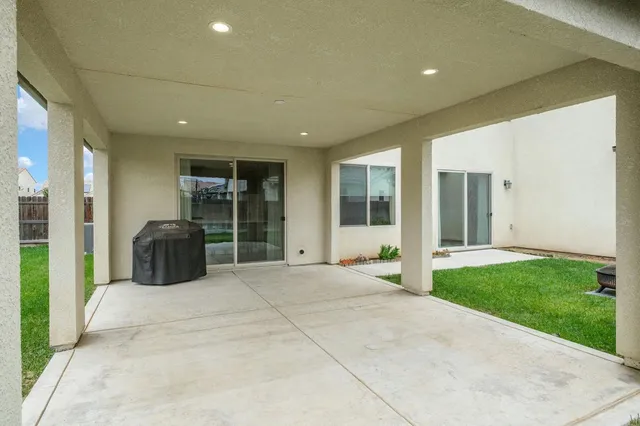 a view of a house with a yard and porch
