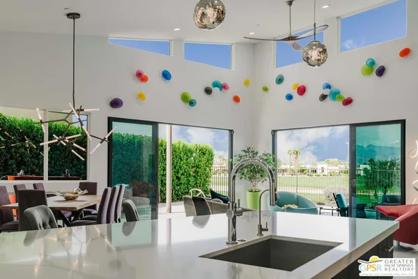 a bedroom with a bed a couch and a chandelier