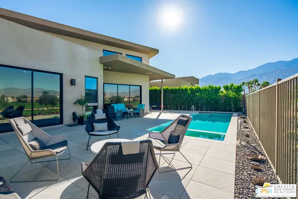 a view of swimming pool and deck in the backyard