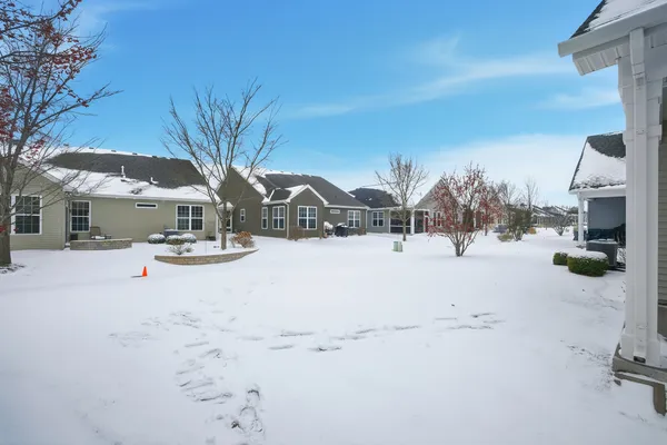 a view of house with snow on the road