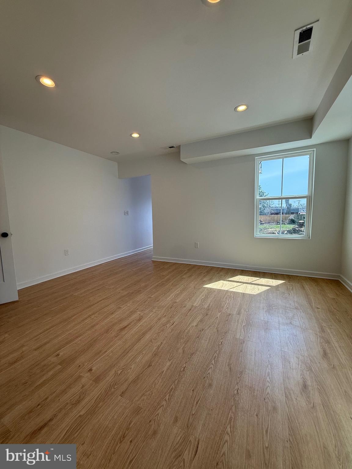 2125 Oakland Road Middle River, MD 21220 - Photo 4 of 15 an empty room with wooden floor and windows