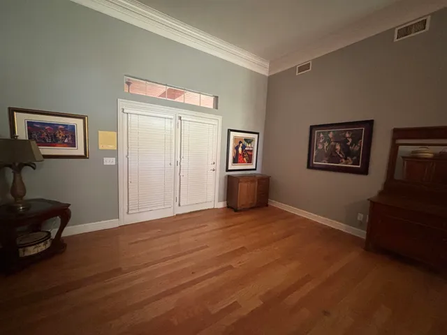 a view of an empty room with furniture and cabinet