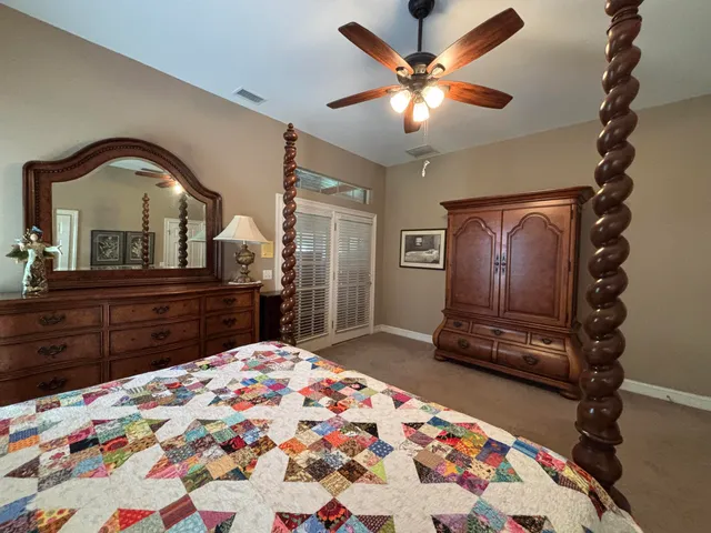 a bedroom with a bed and a dresser