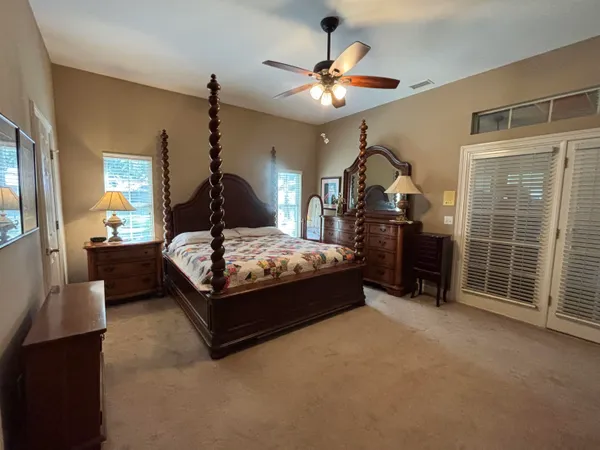 a bedroom with a bed and a chandelier