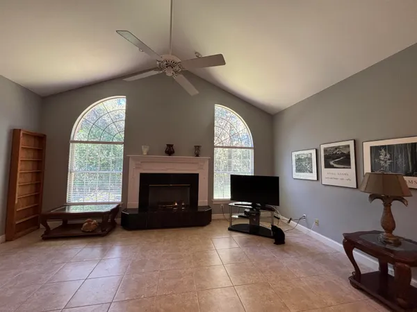 a living room with furniture a fireplace and a flat screen tv