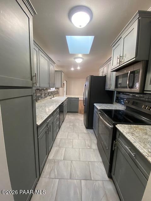 1956 Meadowbrook Road Prescott, AZ 86303 - Photo 2 of 11 a large kitchen with a stove a sink dishwasher a refrigerator and wooden cabinets