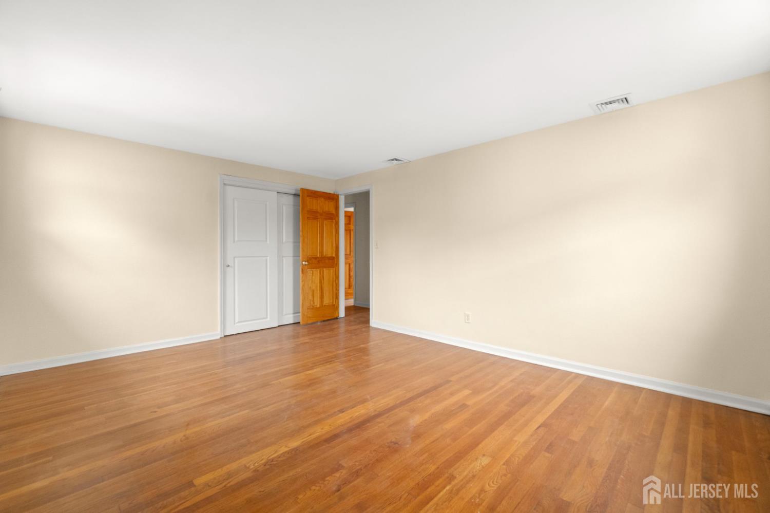 762 Valley Street Maplewood, NJ 07040 - Photo 15 of 21 a view of an empty room with wooden floor and a window