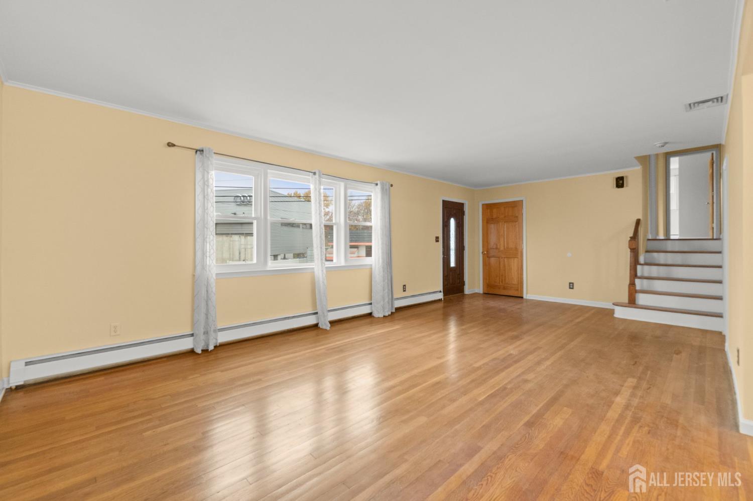 762 Valley Street Maplewood, NJ 07040 - Photo 4 of 21 an empty room with wooden floor and windows