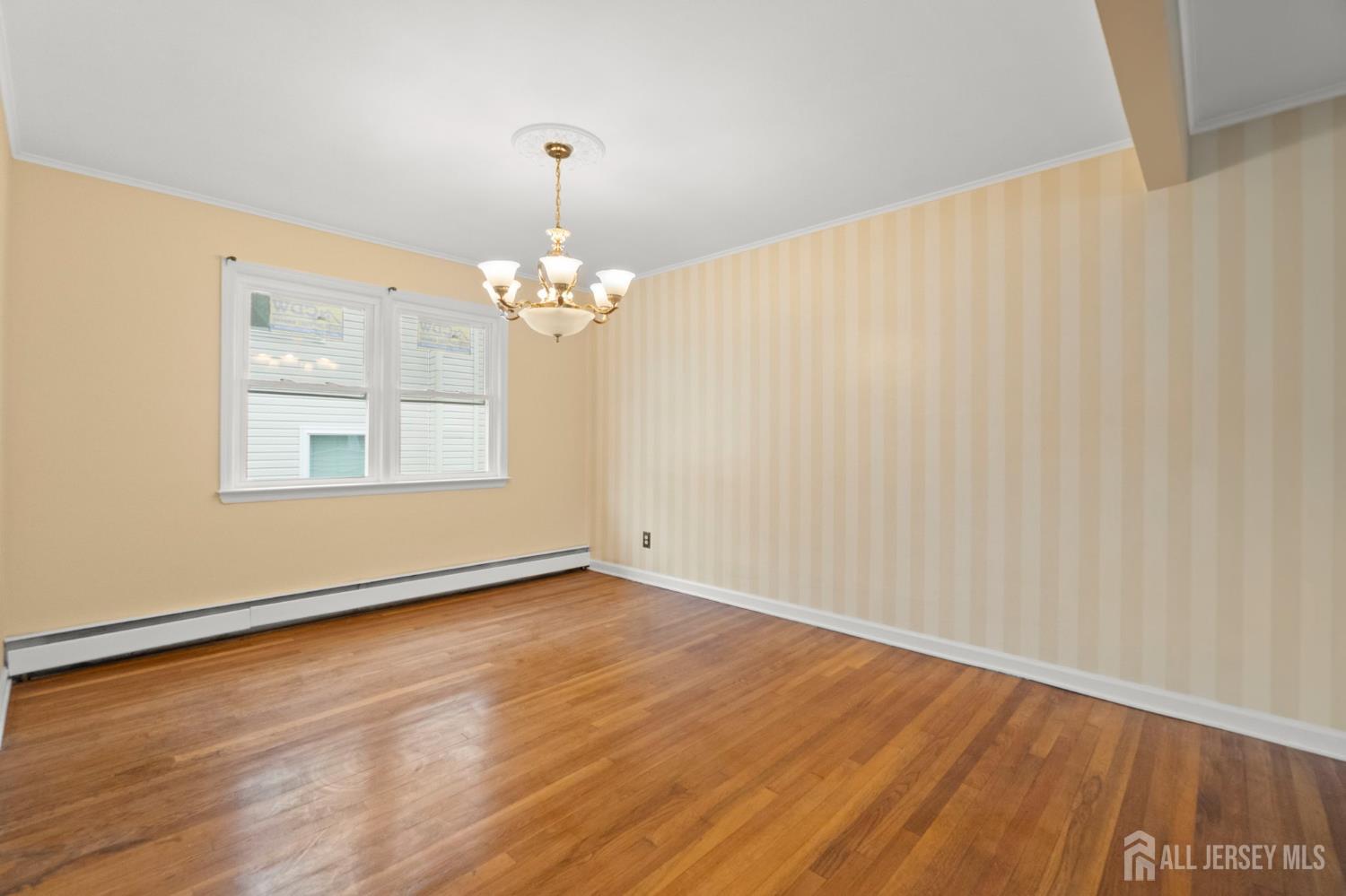 762 Valley Street Maplewood, NJ 07040 - Photo 7 of 21 a view of an empty room with wooden floor and a window