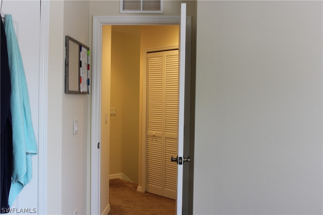 10190 Tin Maple Drive, Unit 130 Estero, FL 33928 - Photo 15 of 17 a view of a hallway with a door