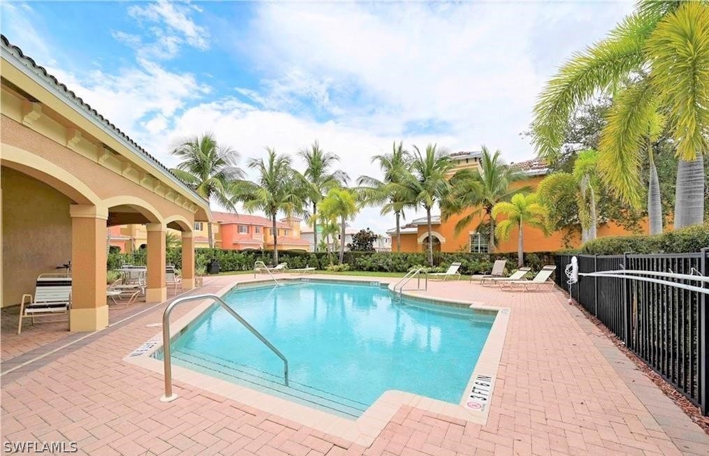 10190 Tin Maple Drive, Unit 130 Estero, FL 33928 - Photo 17 of 17 a view of a swimming pool with a lounge chairs