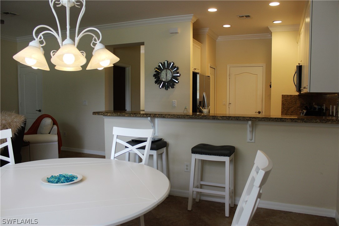 10190 Tin Maple Drive, Unit 130 Estero, FL 33928 - Photo 4 of 17 a dining room with furniture and window