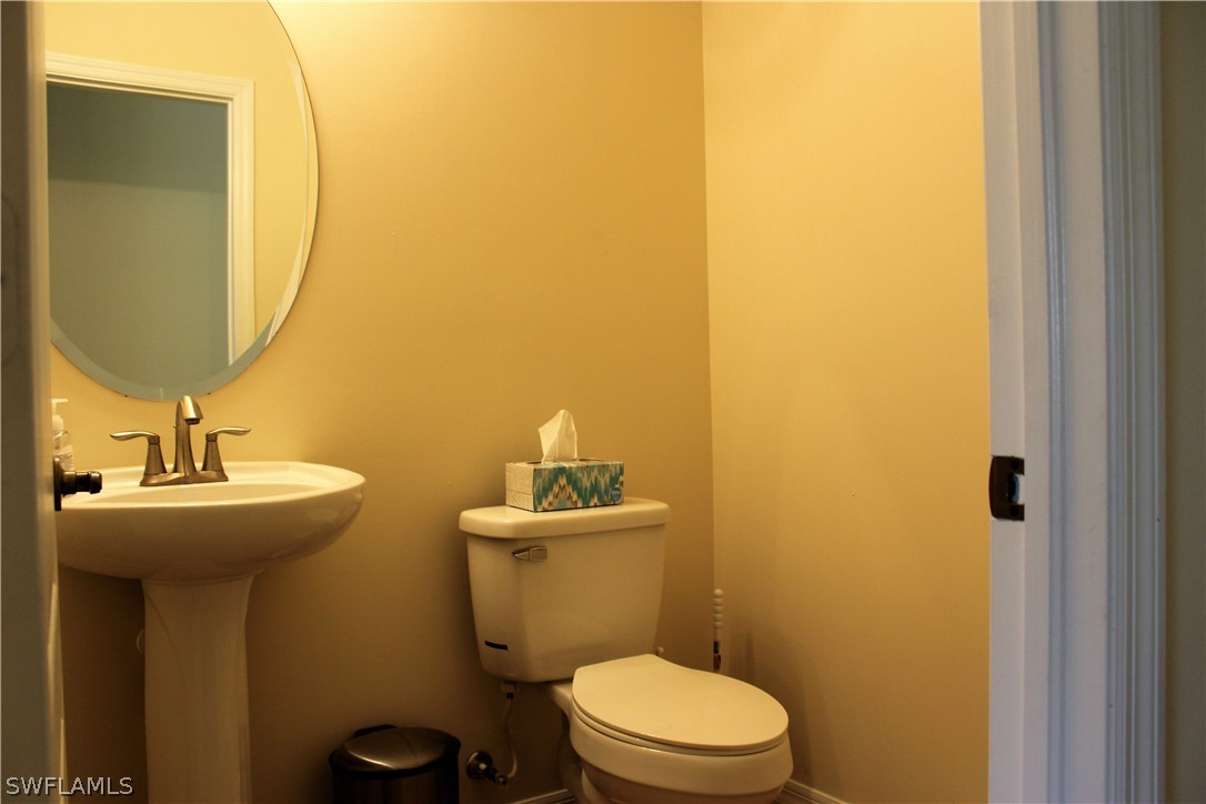 10190 Tin Maple Drive, Unit 130 Estero, FL 33928 - Photo 7 of 17 a bathroom with a sink and a toilet