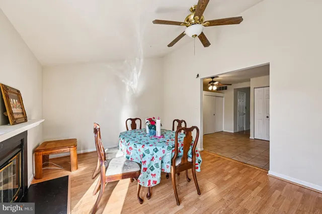 a view of a dining room with furniture and a chandelier fan