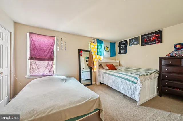 a bedroom with a bed and dresser