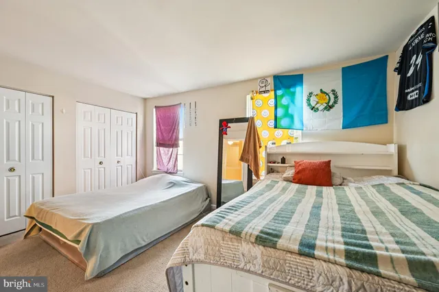 a bedroom with a bed and a night stand