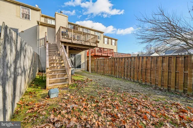 a view of a house with wooden fence