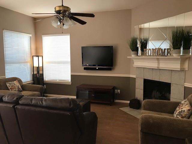 1702 Sunflower Drive Corinth, TX 76210 - Photo 7 of 12 a living room with furniture and a flat screen tv
