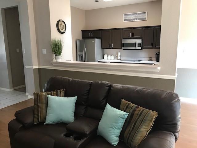 1702 Sunflower Drive Corinth, TX 76210 - Photo 8 of 12 a living room with furniture and a flat screen tv