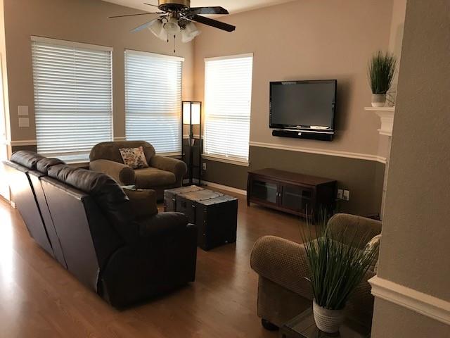 1702 Sunflower Drive Corinth, TX 76210 - Photo 9 of 12 a living room with furniture and a flat screen tv