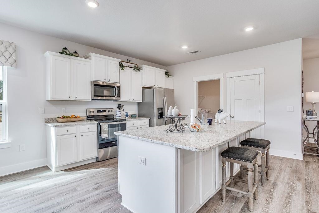 7637 Saddlebrook Avenue Pace, FL 32571 - Photo 13 of 28 a kitchen with sink a microwave and cabinets