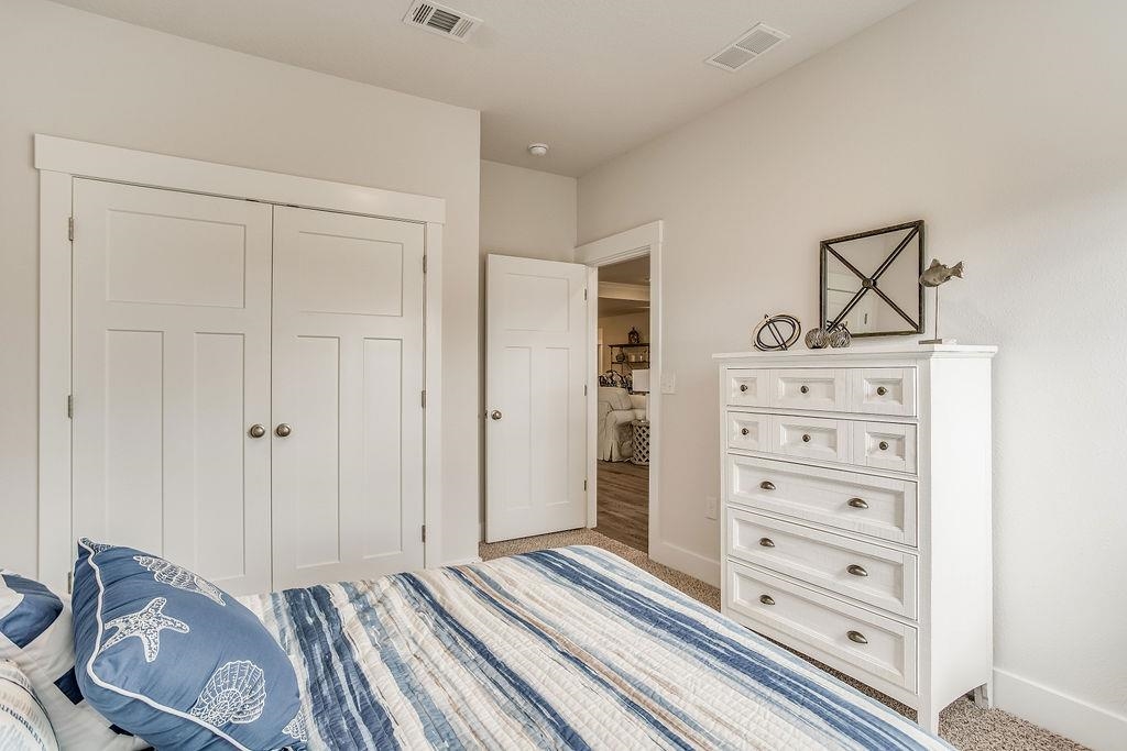 7637 Saddlebrook Avenue Pace, FL 32571 - Photo 18 of 28 a view of bedroom with furniture and cabinet