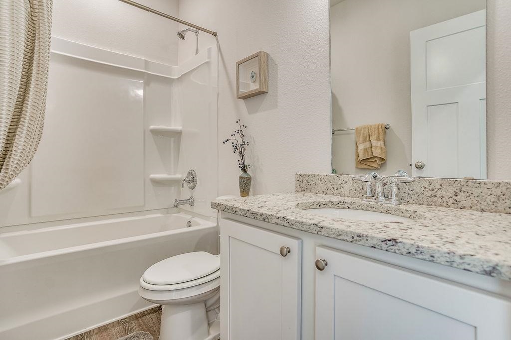 7637 Saddlebrook Avenue Pace, FL 32571 - Photo 19 of 28 a bathroom with a granite countertop sink toilet and shower