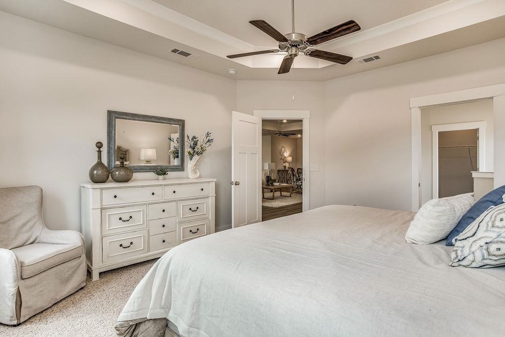 7637 Saddlebrook Avenue Pace, FL 32571 - Photo 21 of 28 a bedroom with a bed a couches and dresser