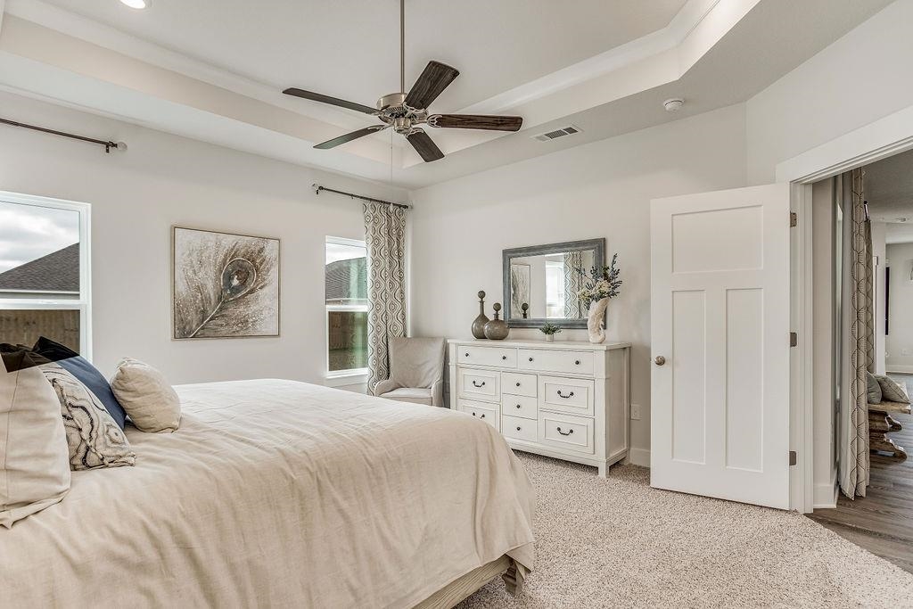 7637 Saddlebrook Avenue Pace, FL 32571 - Photo 22 of 28 a bedroom with a bed and a chandelier