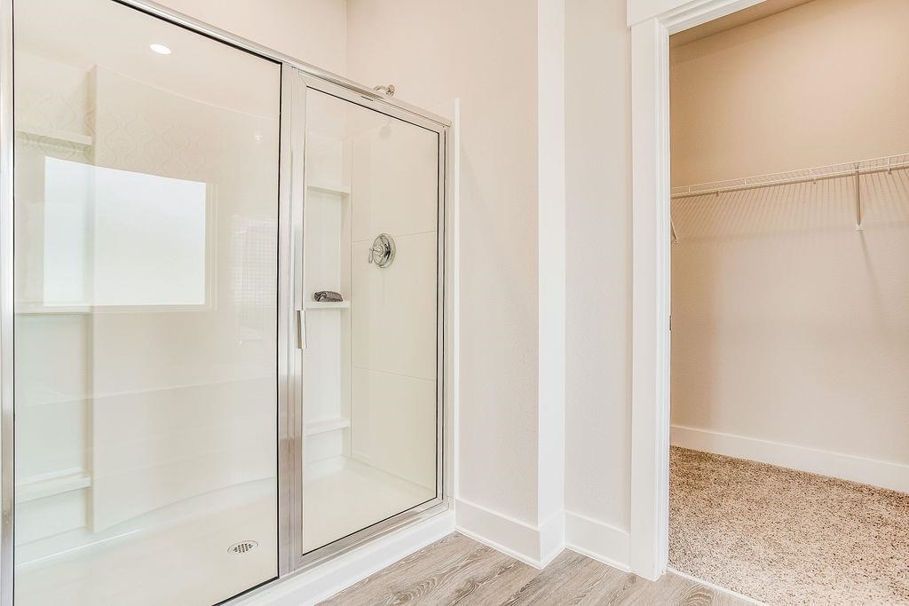 7637 Saddlebrook Avenue Pace, FL 32571 - Photo 27 of 28 a bathroom with a glass shower door