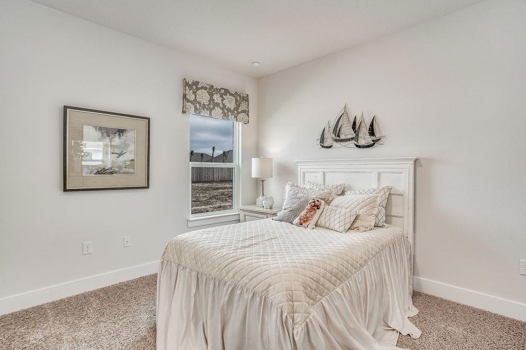 7637 Saddlebrook Avenue Pace, FL 32571 - Photo 4 of 28 a bedroom with a bed and painting on the wall