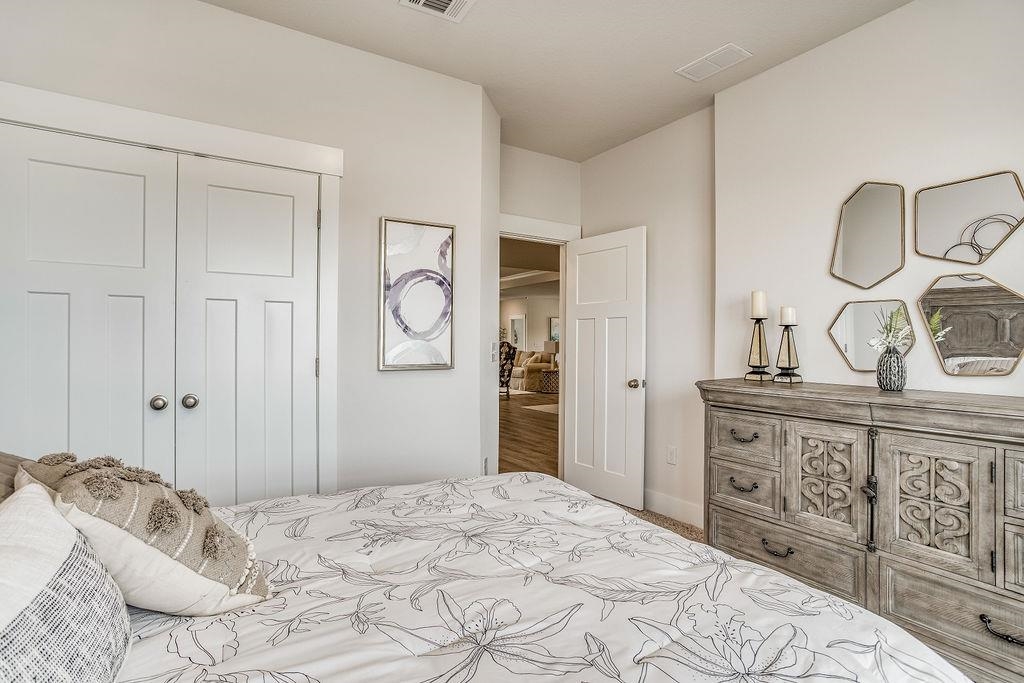 7637 Saddlebrook Avenue Pace, FL 32571 - Photo 7 of 28 a bedroom with a bed and a dresser