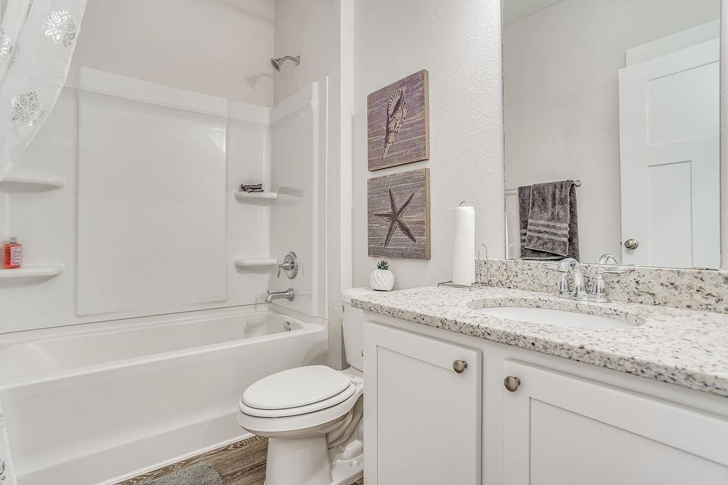 7637 Saddlebrook Avenue Pace, FL 32571 - Photo 8 of 28 a bathroom with a granite countertop sink toilet and shower